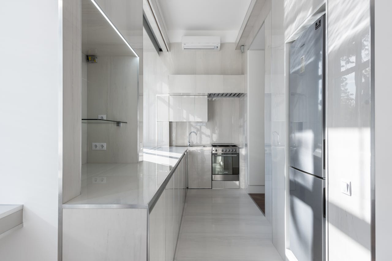 Bright and modern kitchen interior with minimalist design and sleek appliances.